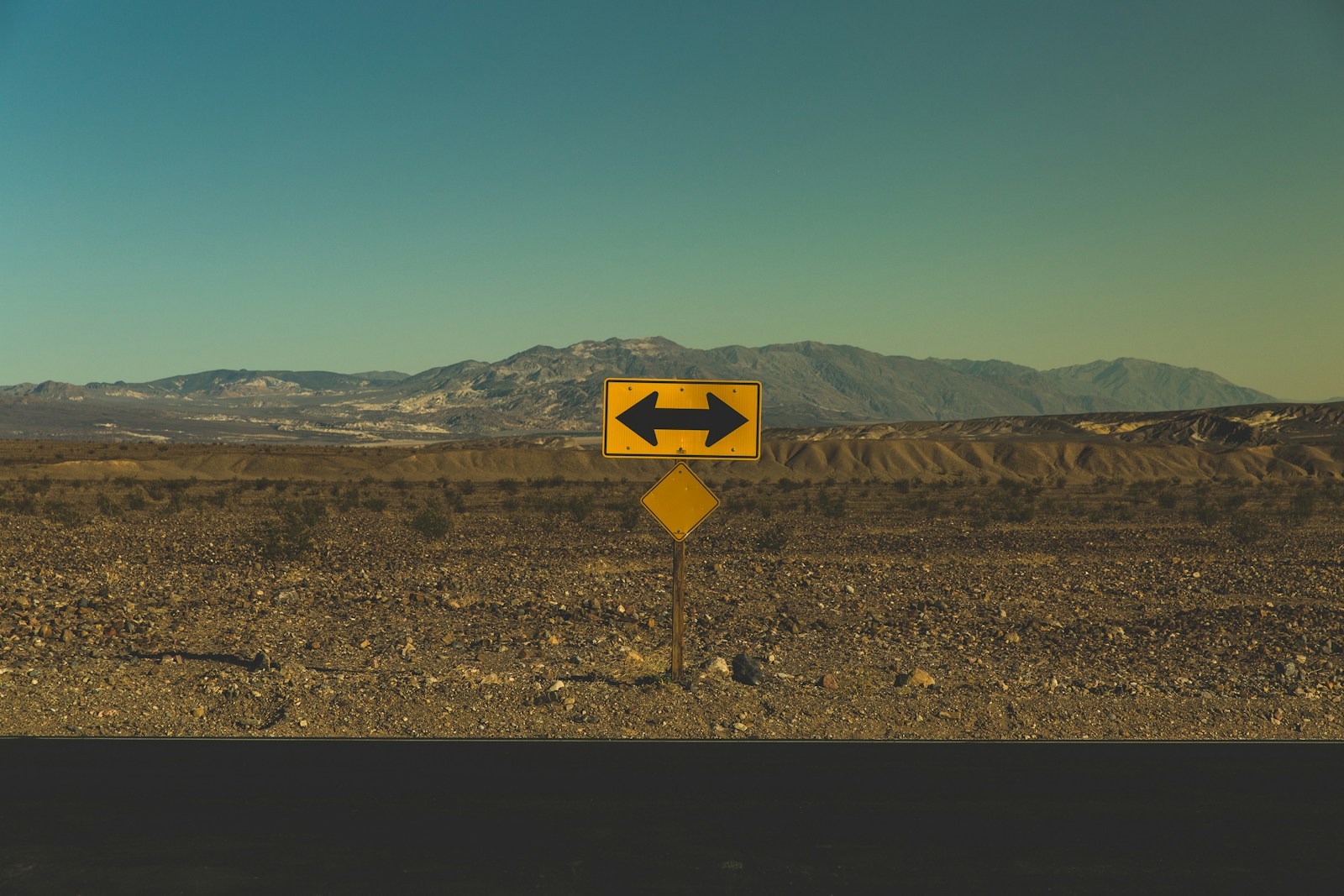 Photo by Pablo García Saldaña yellow arrow road sign