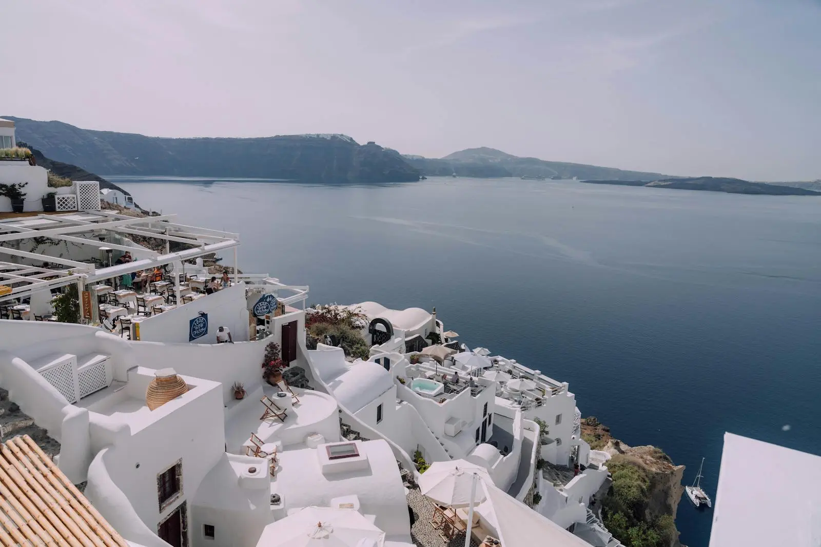 Stunning Santorini view capturing the iconic whitewashed buildings against a blue sea and sky.