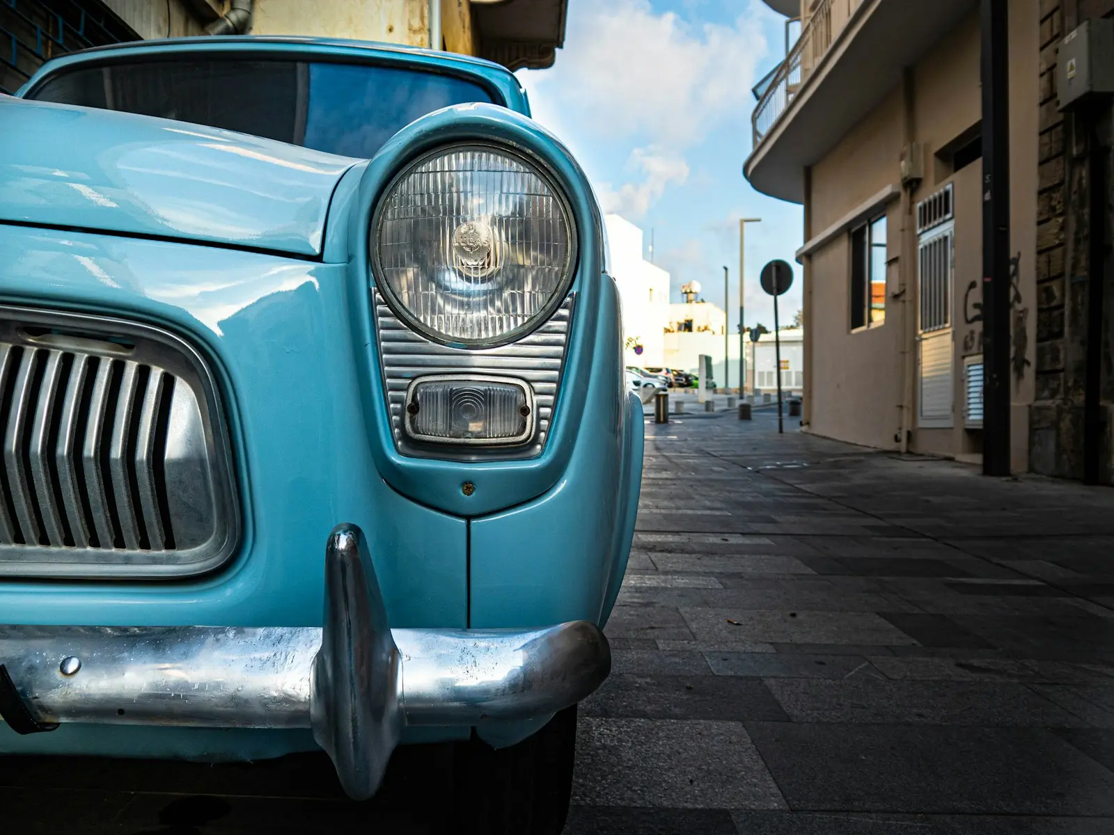 a blue car parked on a street