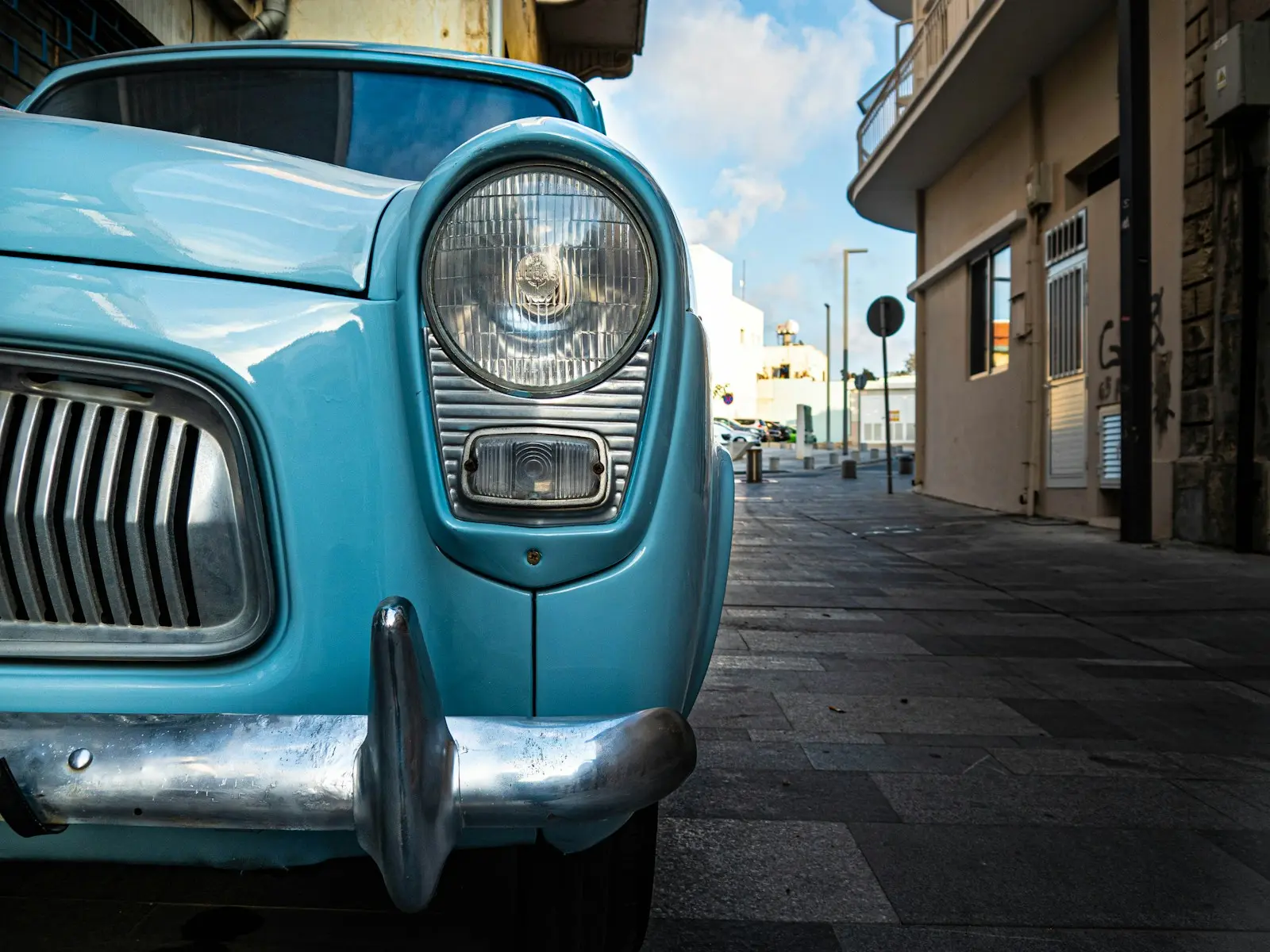 a blue car parked on a street