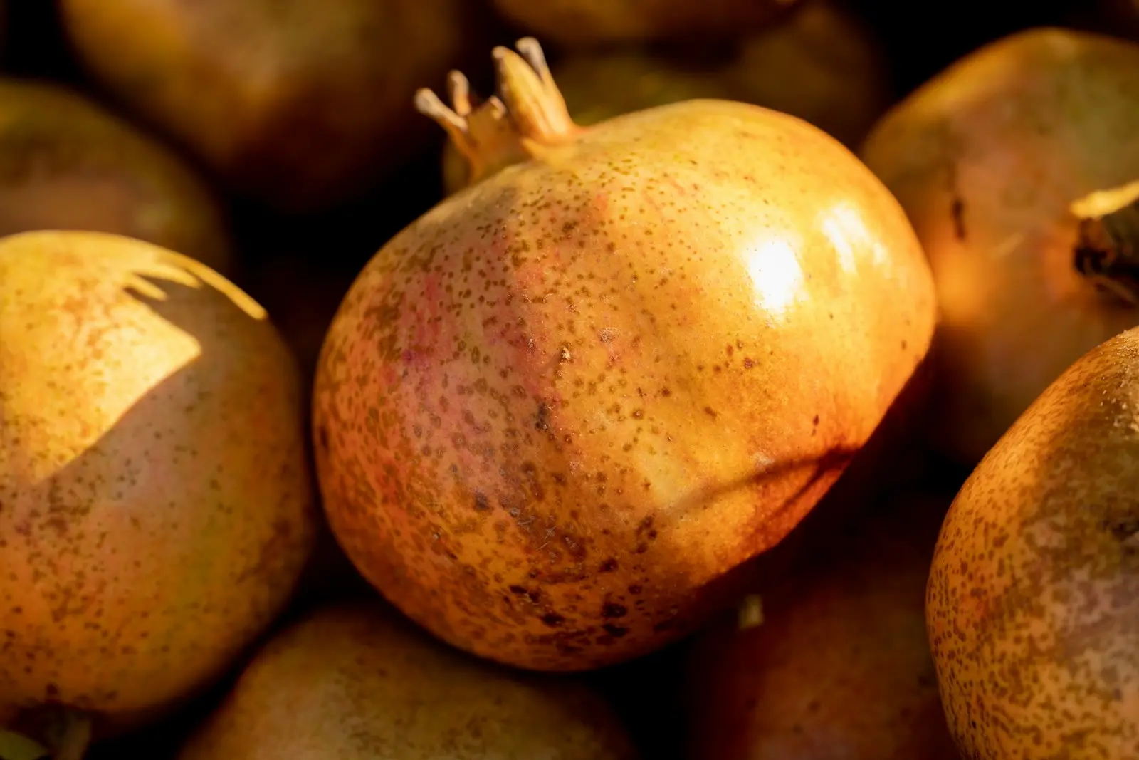 a pile of pomegranates sitting on top of each other