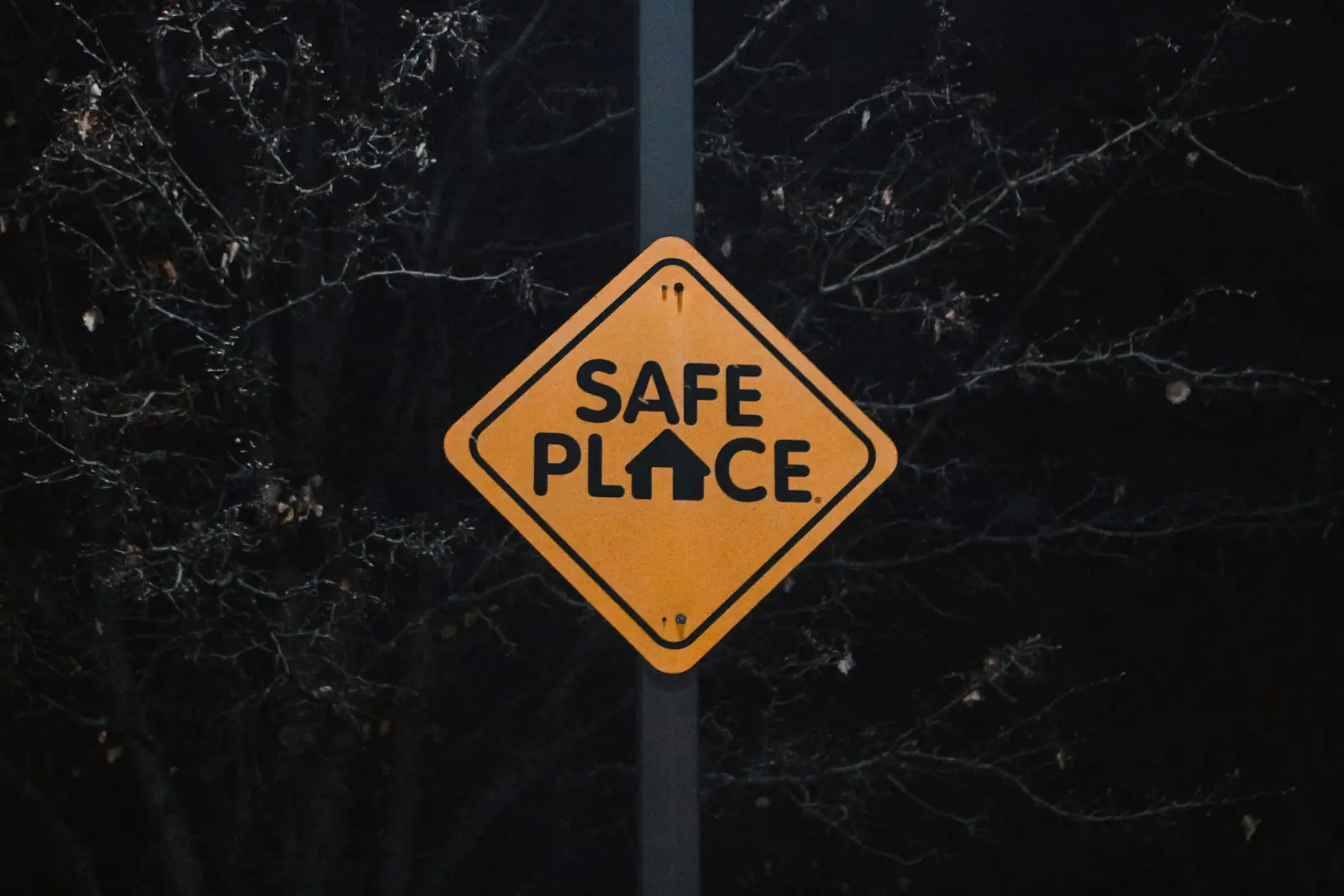 A yellow sign that says safe place on it