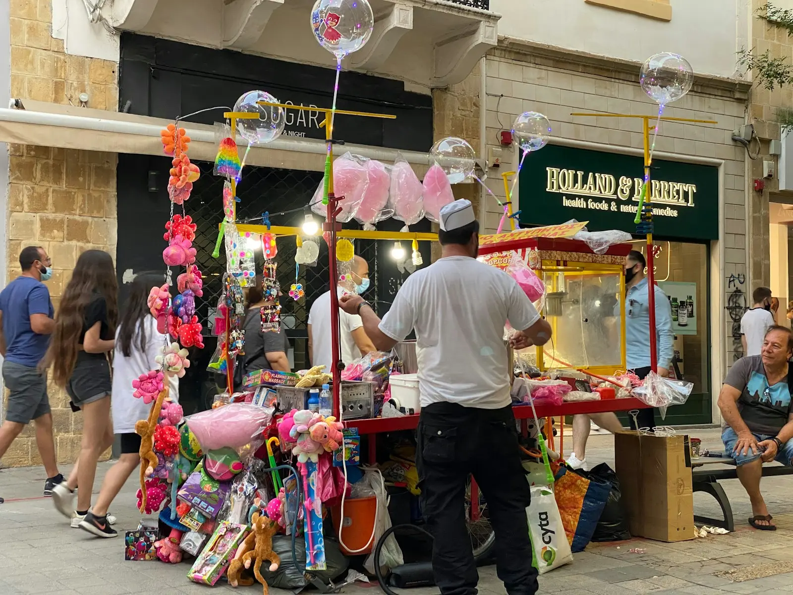 a man standing in front of a street vendor
